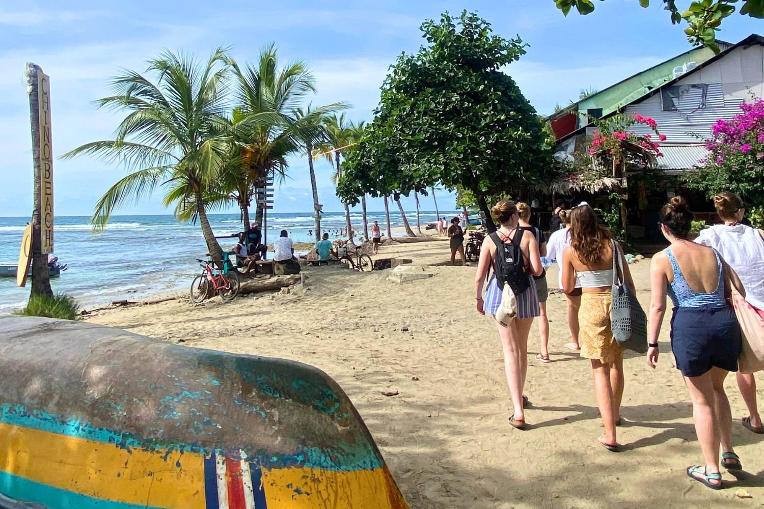 Group of travellers walking along a sandy beach in Costa Rica