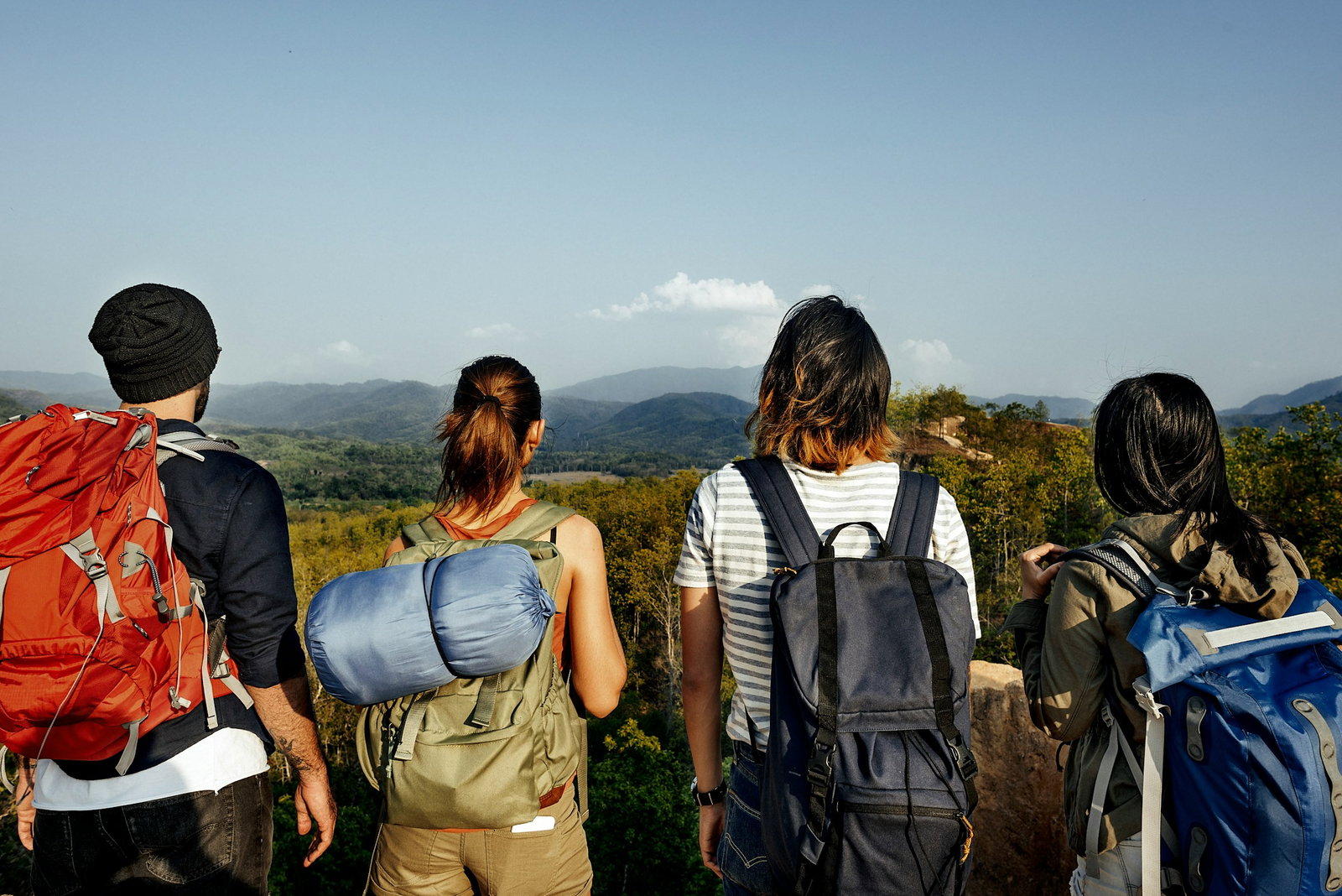 A group of backpackers looking at mountains in the distance