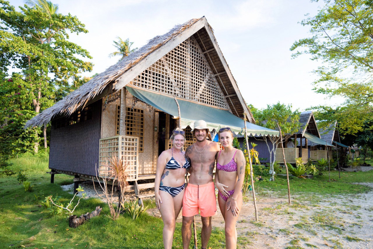 Group standing next to boat trip accommodation hunt in the philippines