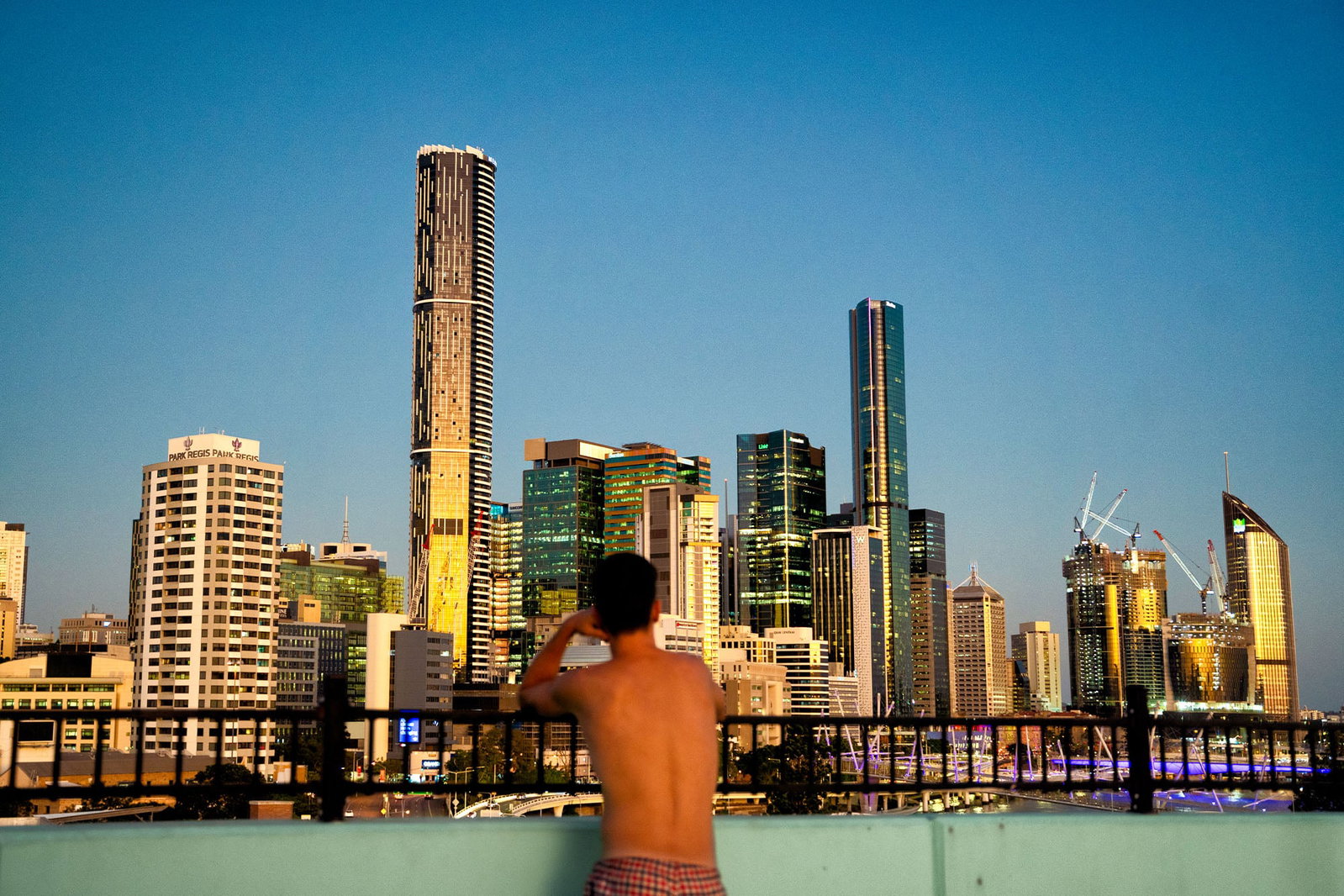 Person looking over Brisbane Skyline at night 