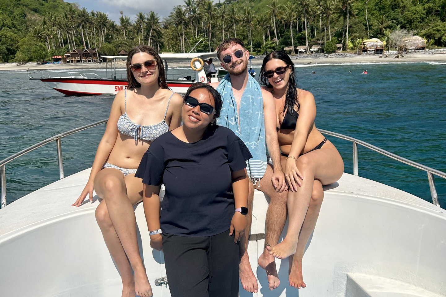 Traveller with their group leader on a boat in Bali