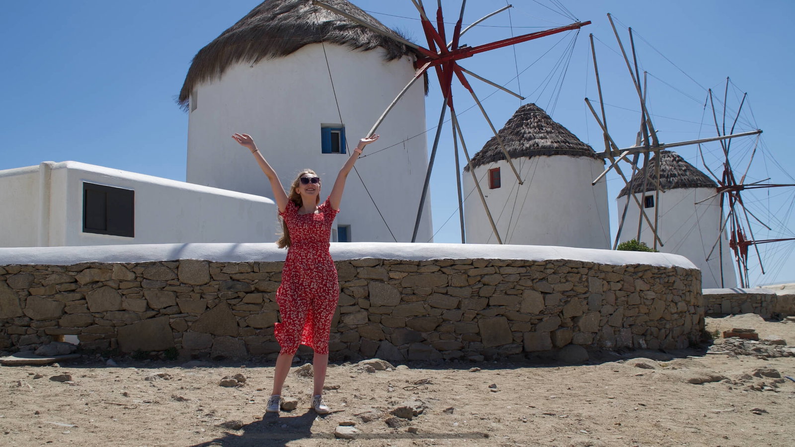 Adventure360 traveller in front of windmills in Mykonos