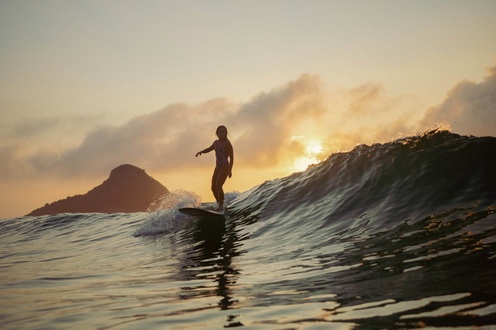female traveller surfing on fitness trip in Australia