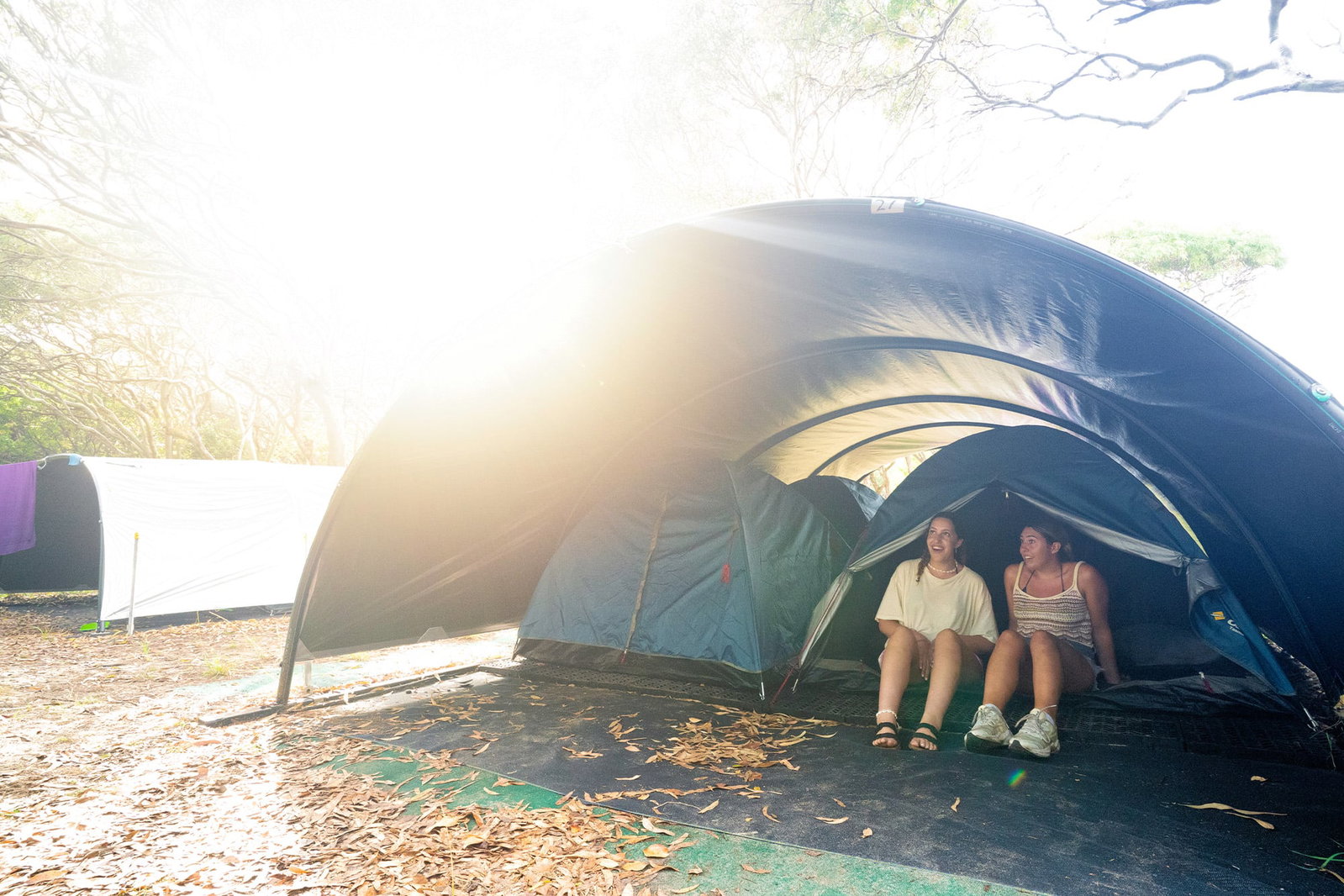 People sat in tents in Kgari camping accommodation