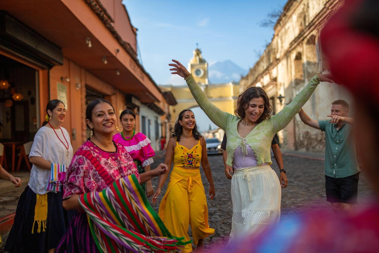 Travellers dancing down street in Antigua