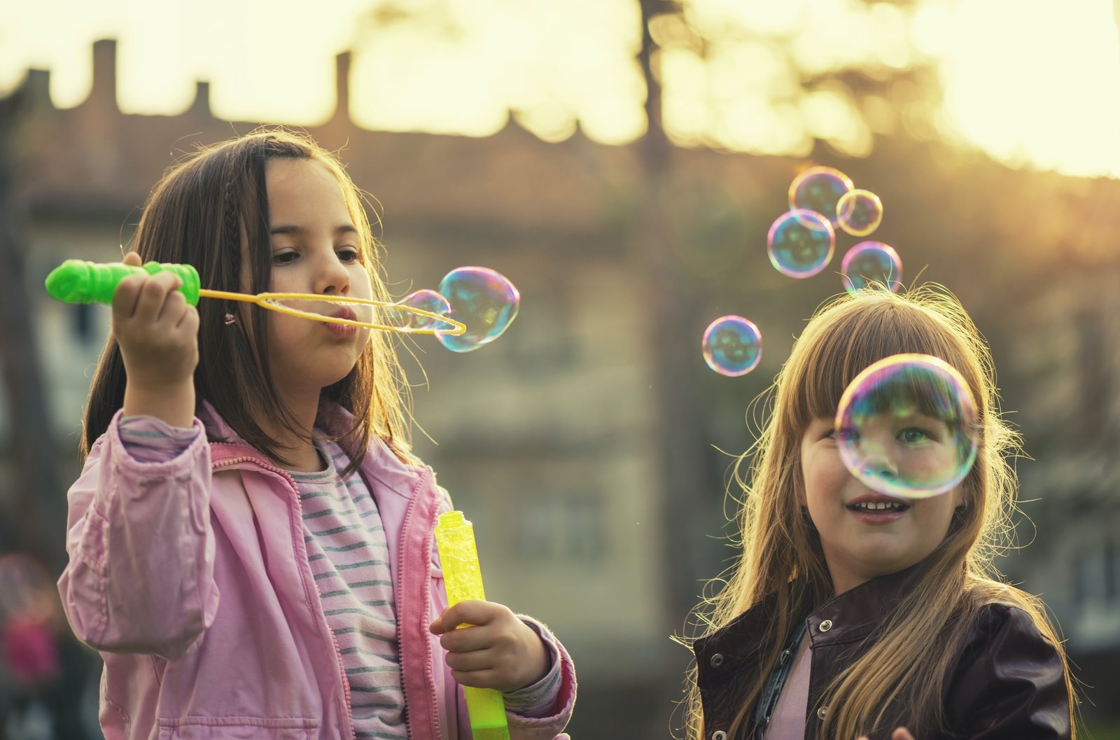Two children blowing bubbles