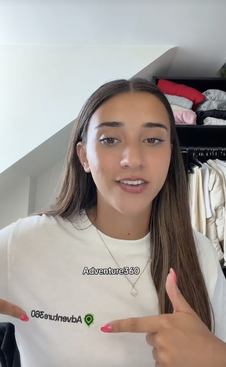 Traveller talking to the camera about Adventure360's rebrand wearing Adventure360 merch