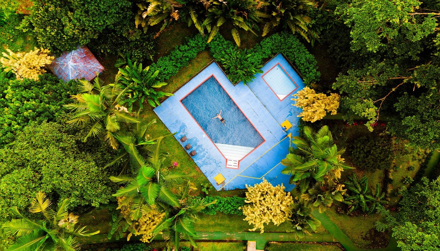 Drone image of a swimming pool near rainforest in Costa Rica 