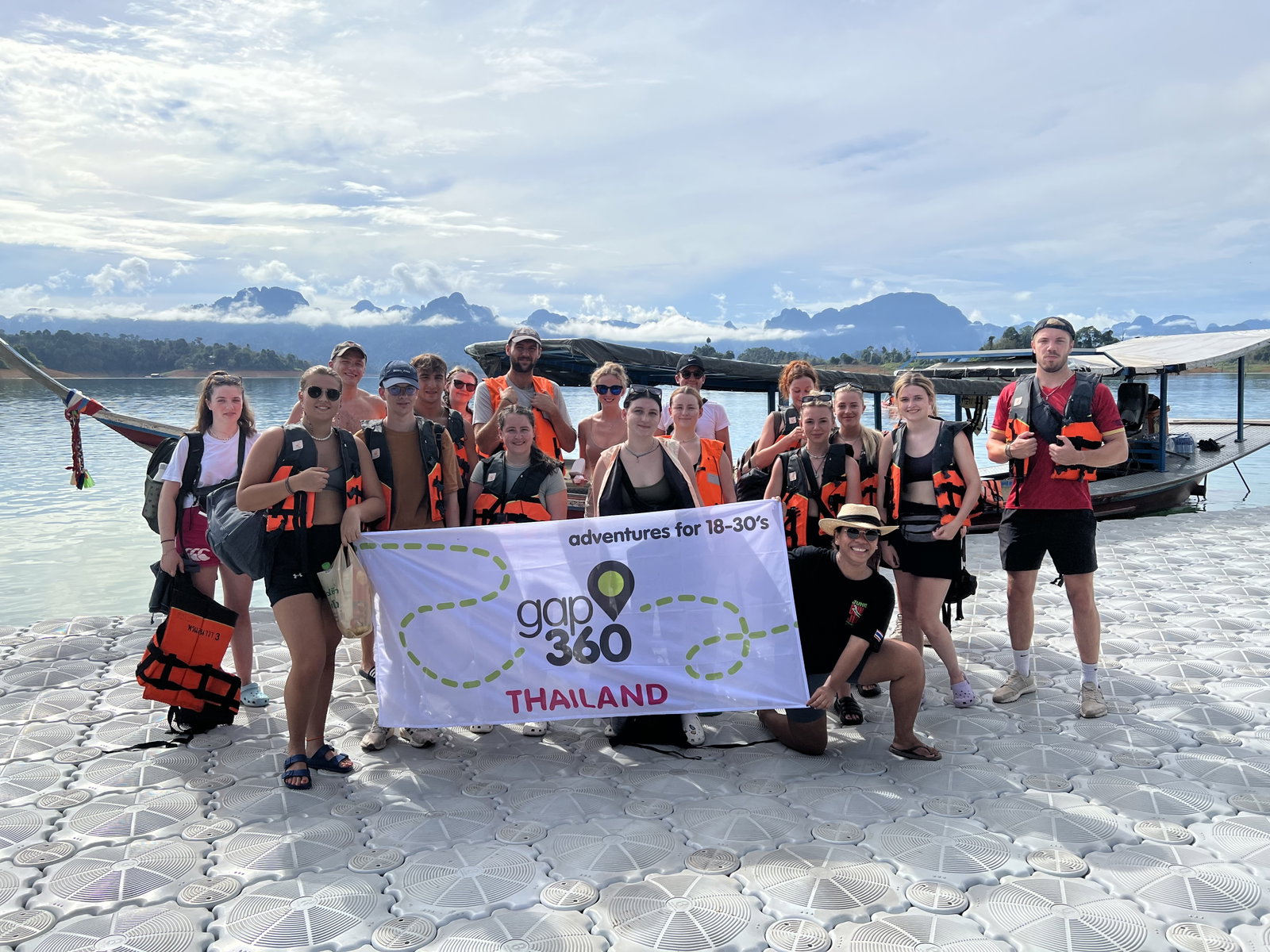 Travellers holding up an Adventure360 Thailand banner