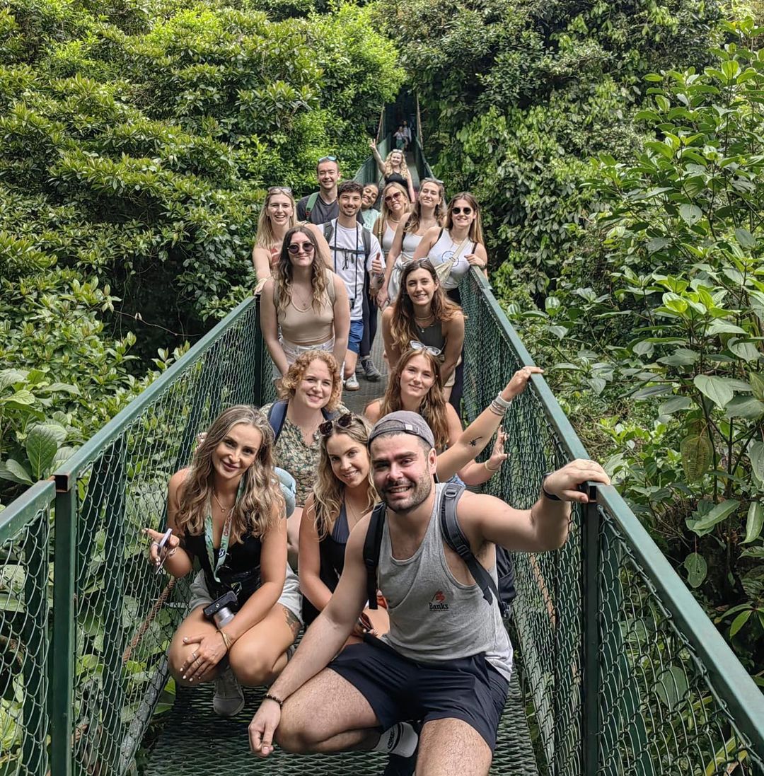 Group travellers on bridge over La Fortuna Cloud Forest in Costa Rica