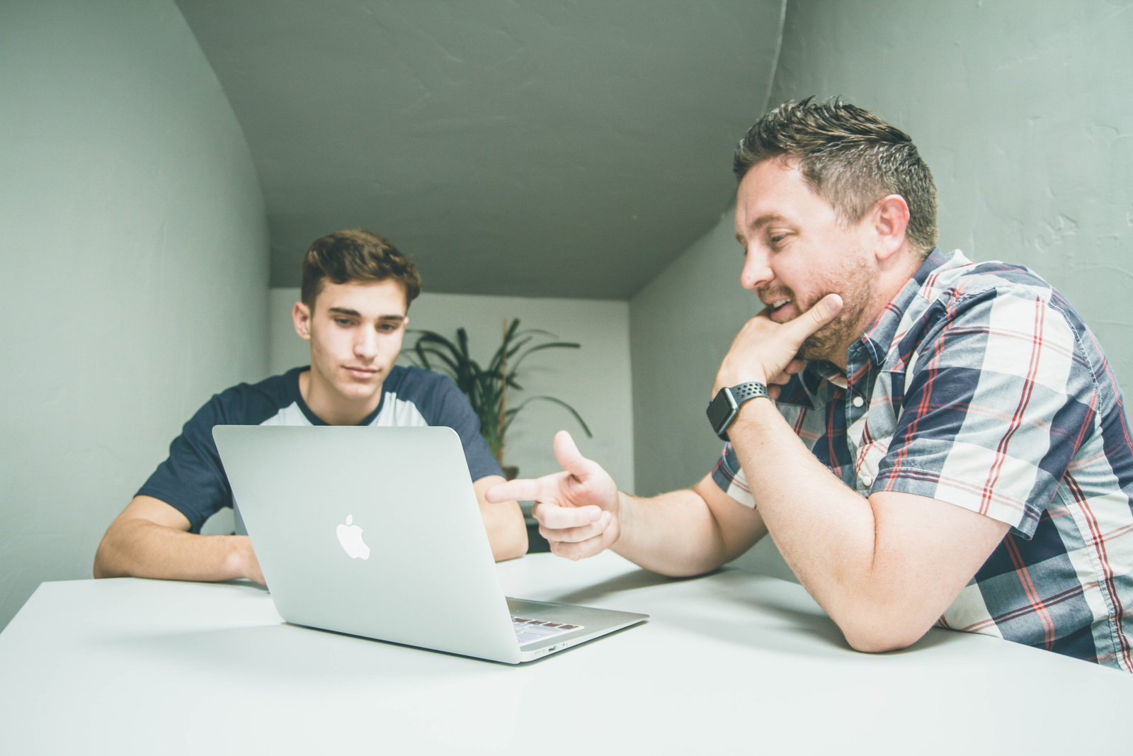 Parent and young adult planning for travels on a laptop