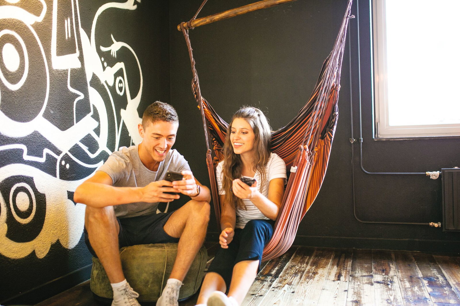 Travellers in hammock at hostel in europe