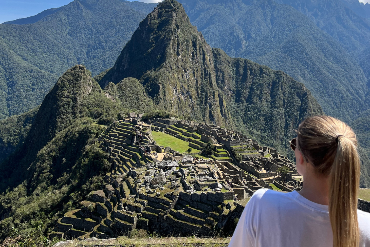 Traveller looking across to one of the Seven Wonders of the World, Machu Picchu, in Peru