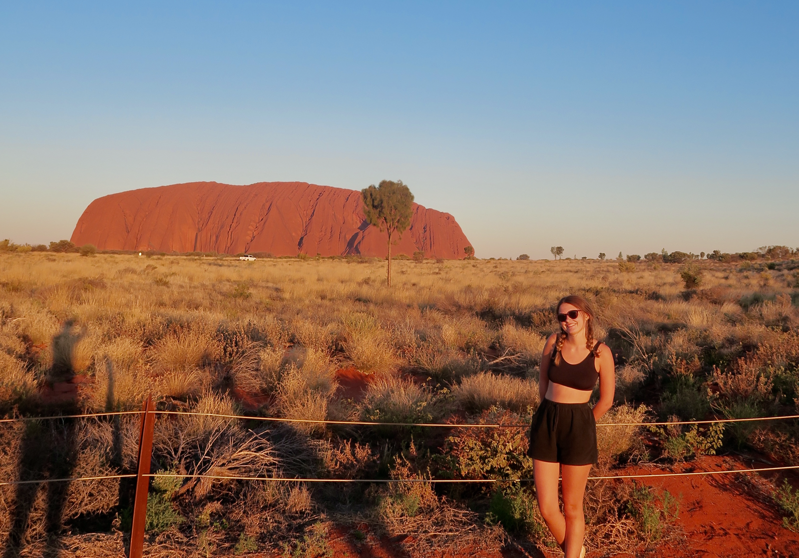 Traveller in front of Uluru in Australia's Northern Territory at Sunset