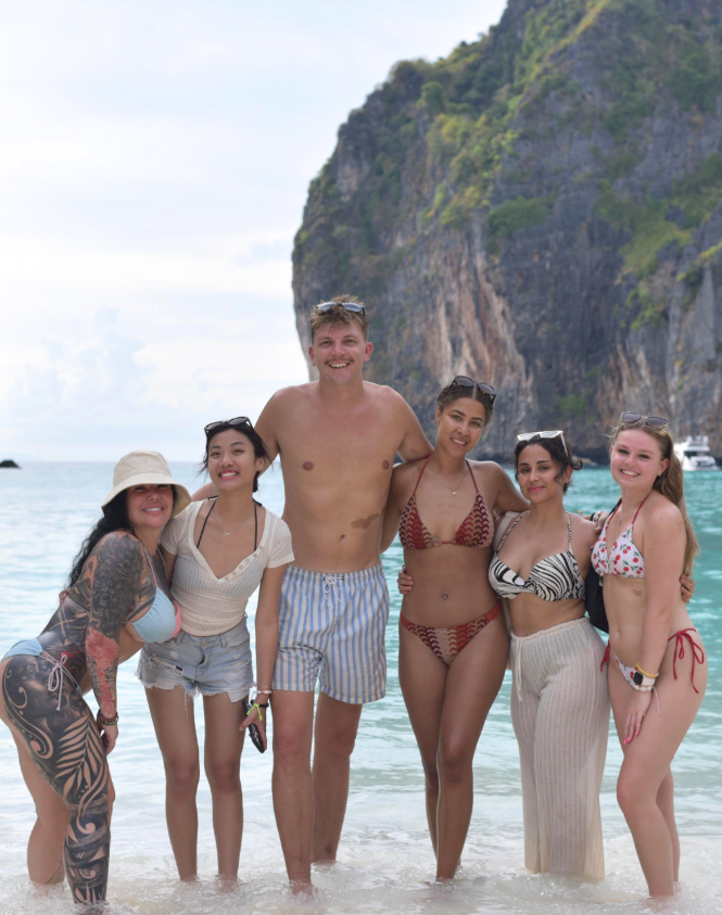 Travellers on the beach in Maya Bay in Thailand
