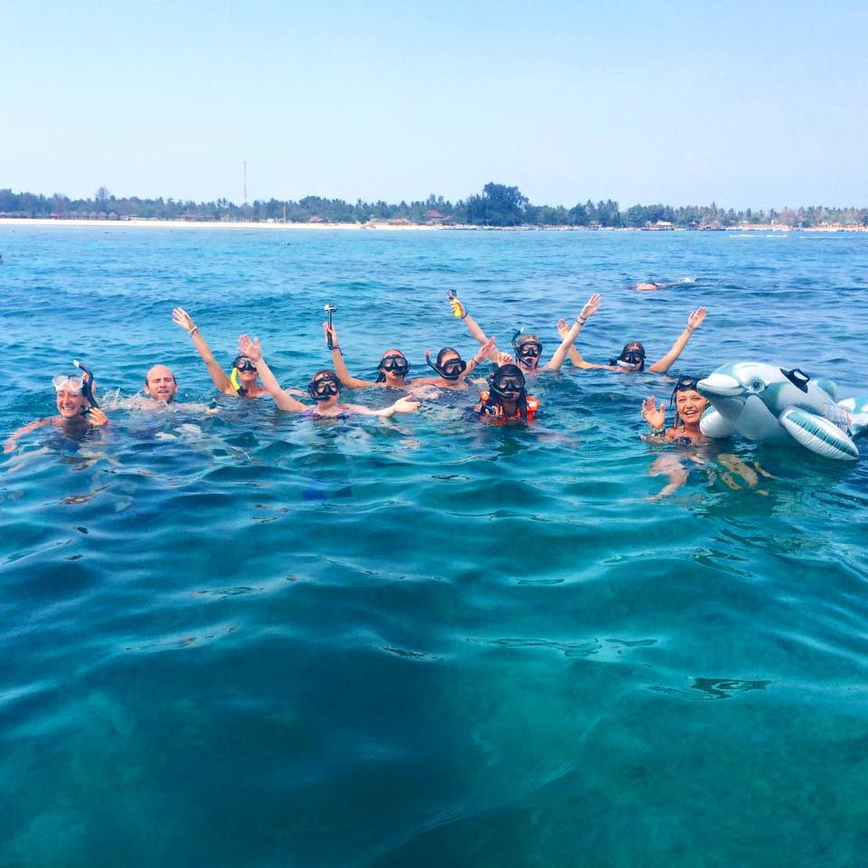 A group of travellers with scuba gear in the water