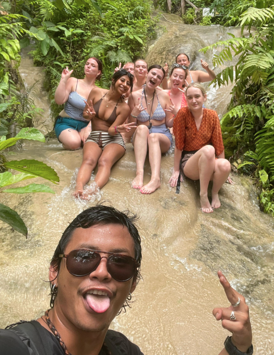Tour guide and group of travellers on Thailand group trip taking a selfie on Chiang Mai's Sticky Waterfalls