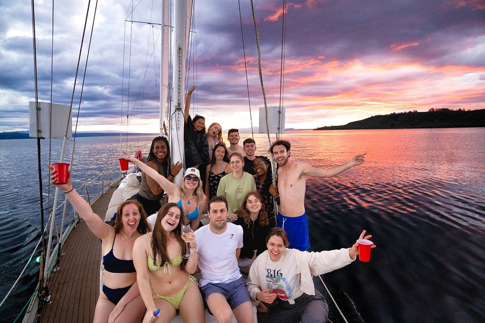 Group travellers on Taupo boat at sunset in New Zealand