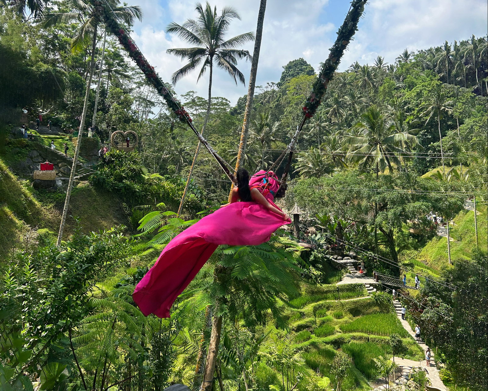Traveller wearing pink dress on the swing at Cretya