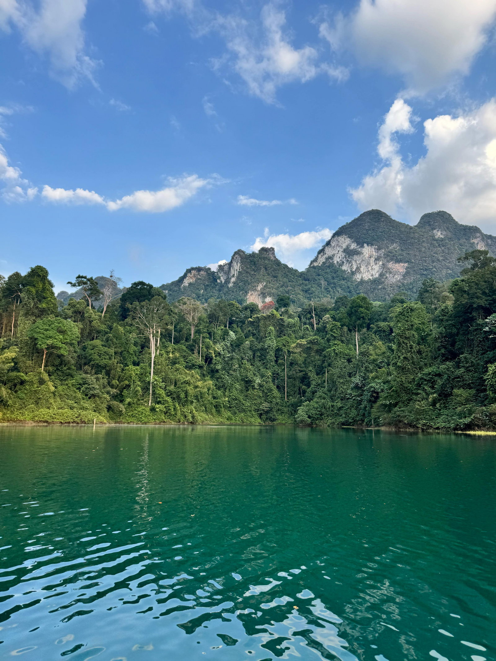 water and mountains in the background in Thailand