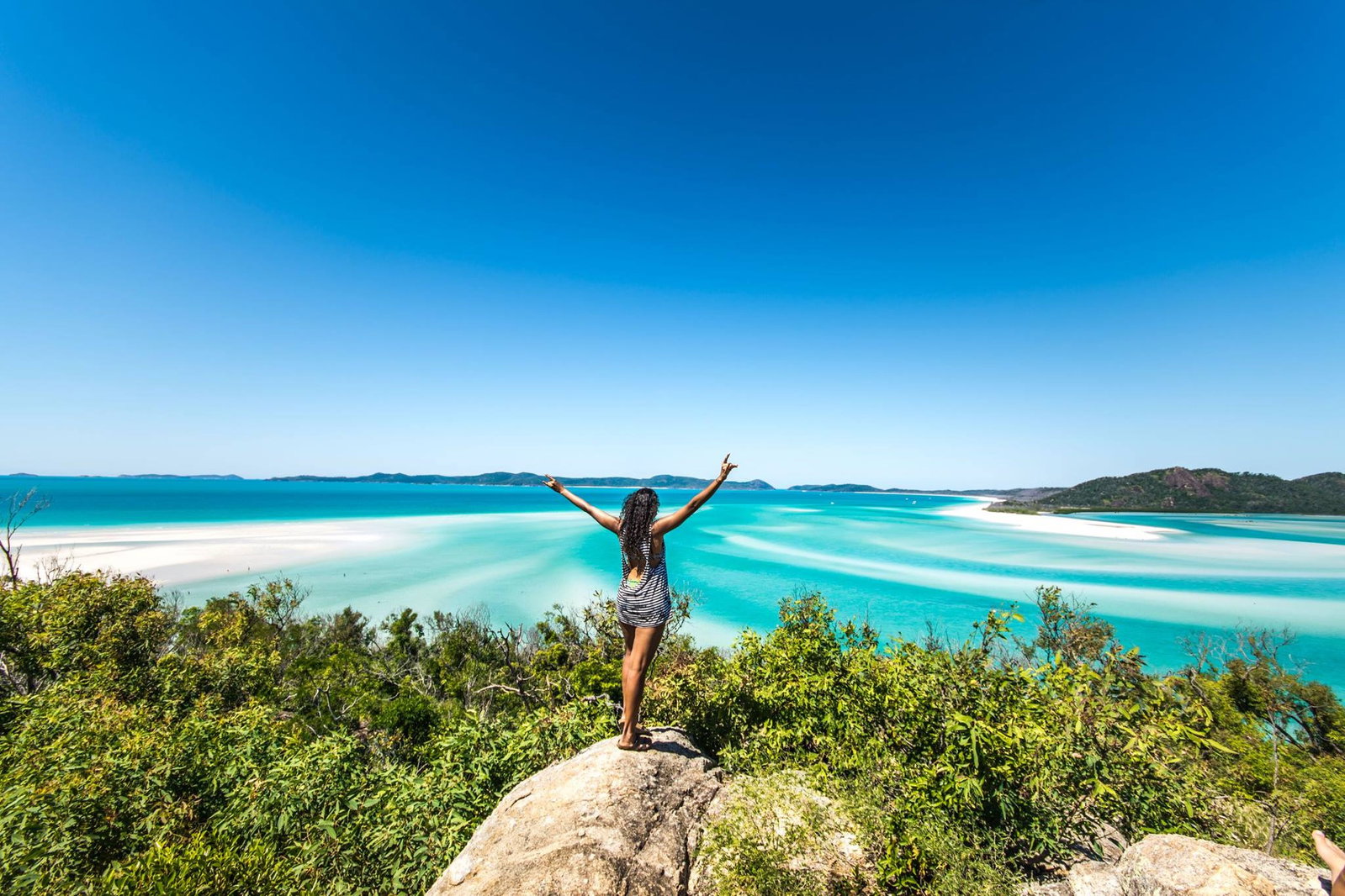 Female group traveller looking over Whitehaven beach in the Whitsundays in Australia